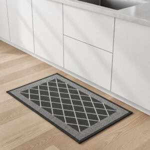 9- Charcoal gray diamond lattice kitchen rug on wood floor beside white kitchen cabinets