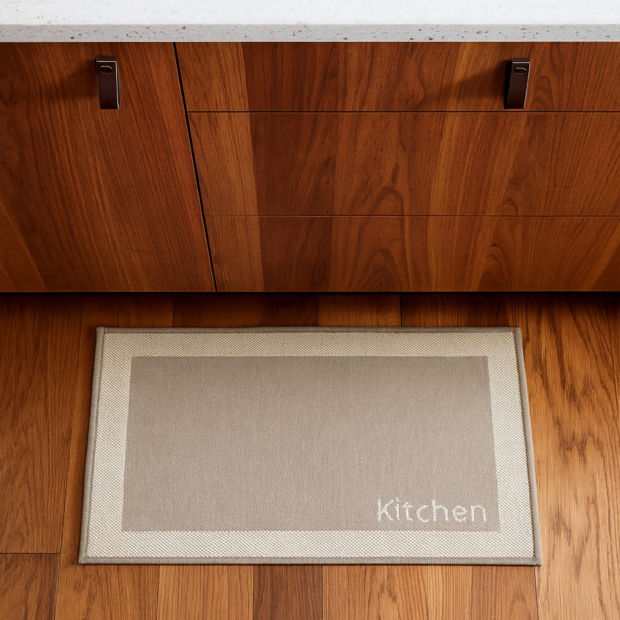 Beige kitchen mat placed in dark cabinet kitchen setting