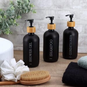 Black dispenser trio displayed in modern bathroom setting