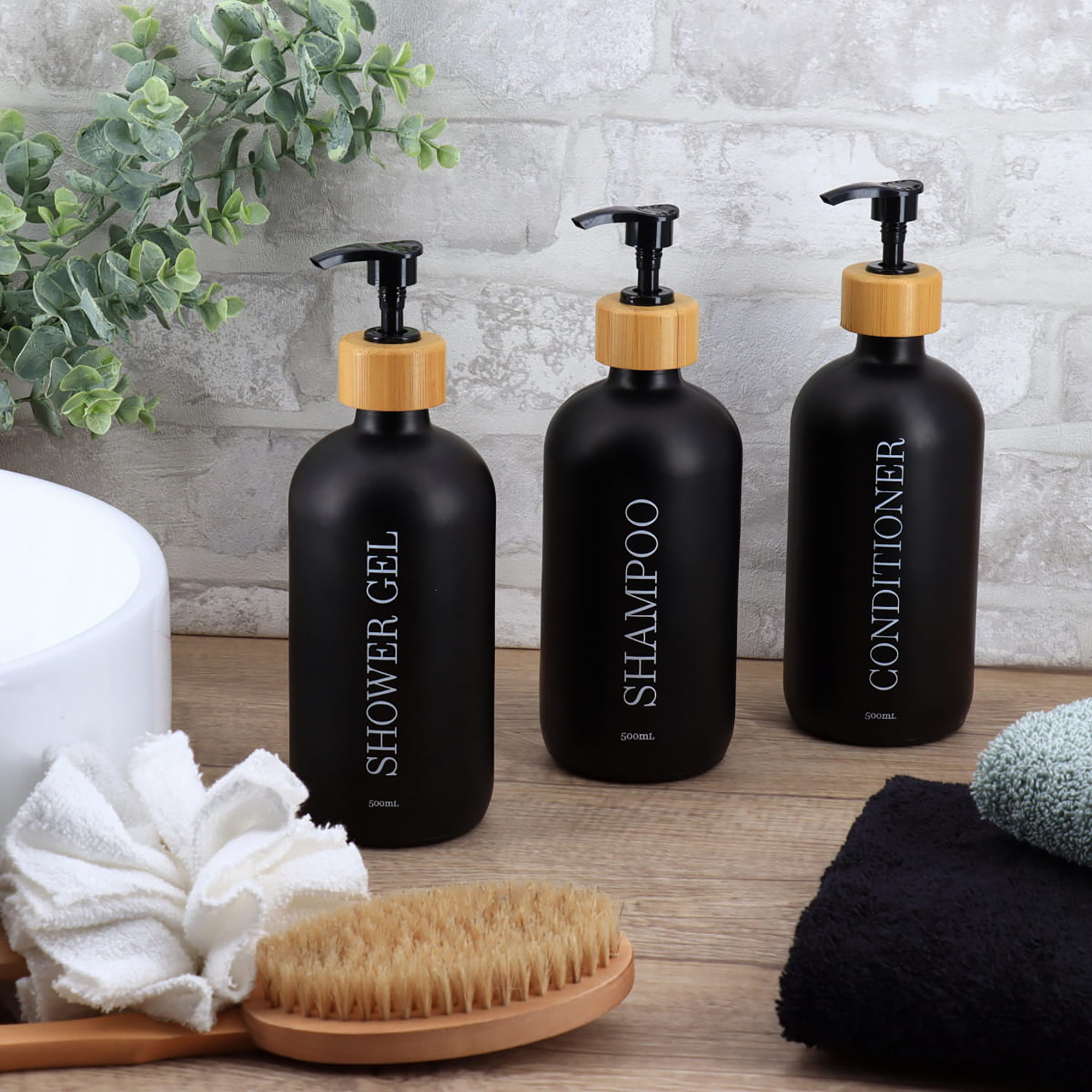 Black dispenser trio displayed in modern bathroom setting