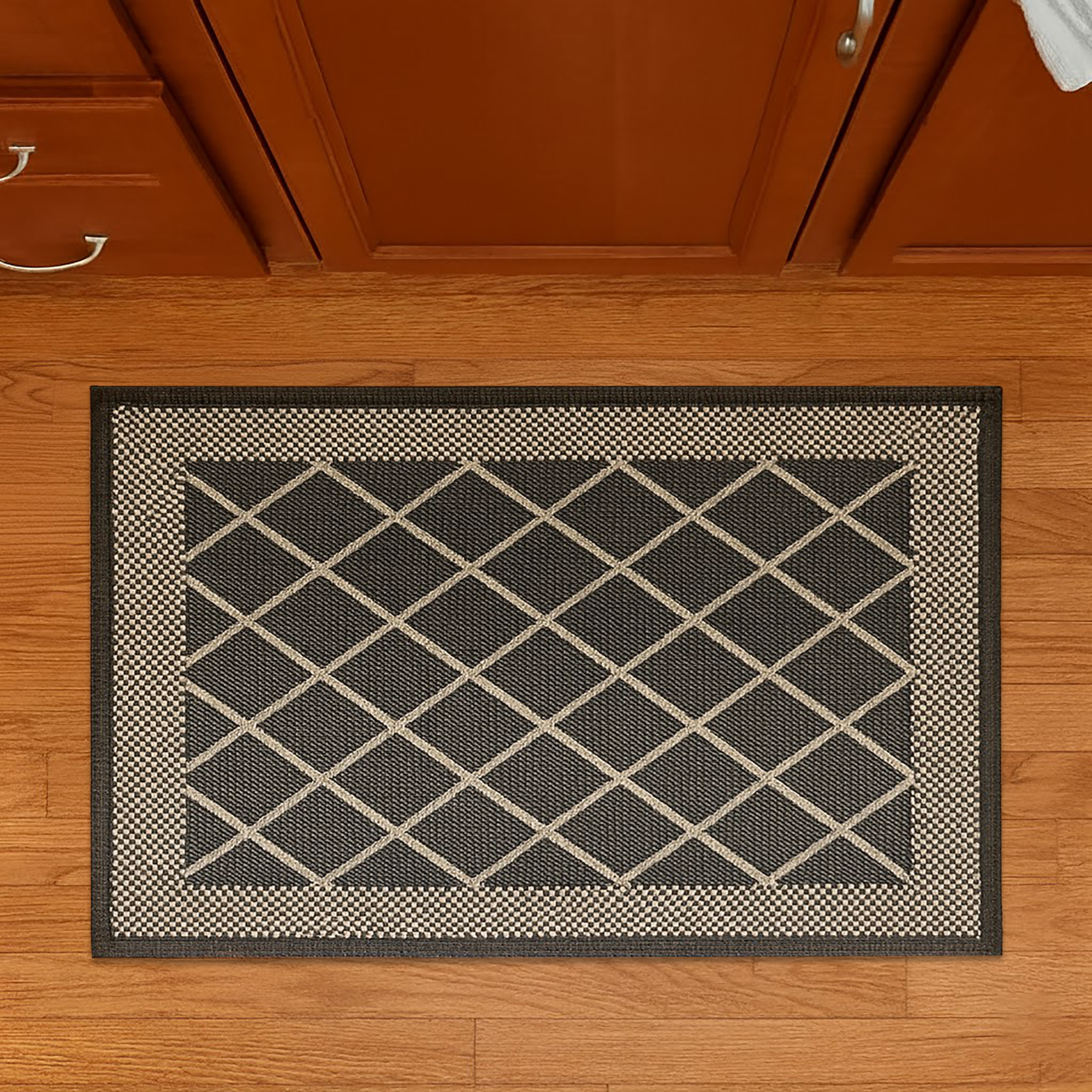 Top view of diamond gray kitchen mat on wood floor