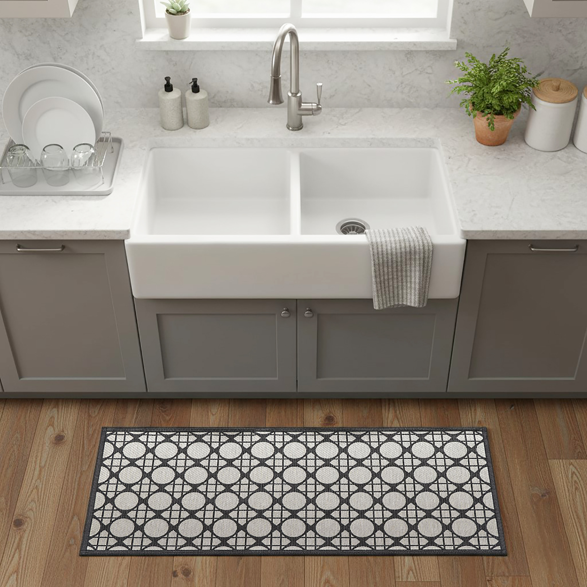 Circles gray kitchen runner placed in front of farmhouse sink