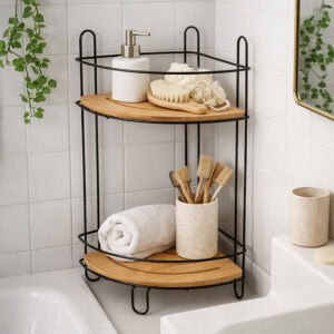 "Black wire corner shelf with bamboo tiers holding towels and toothbrushes on bathtub ledge"