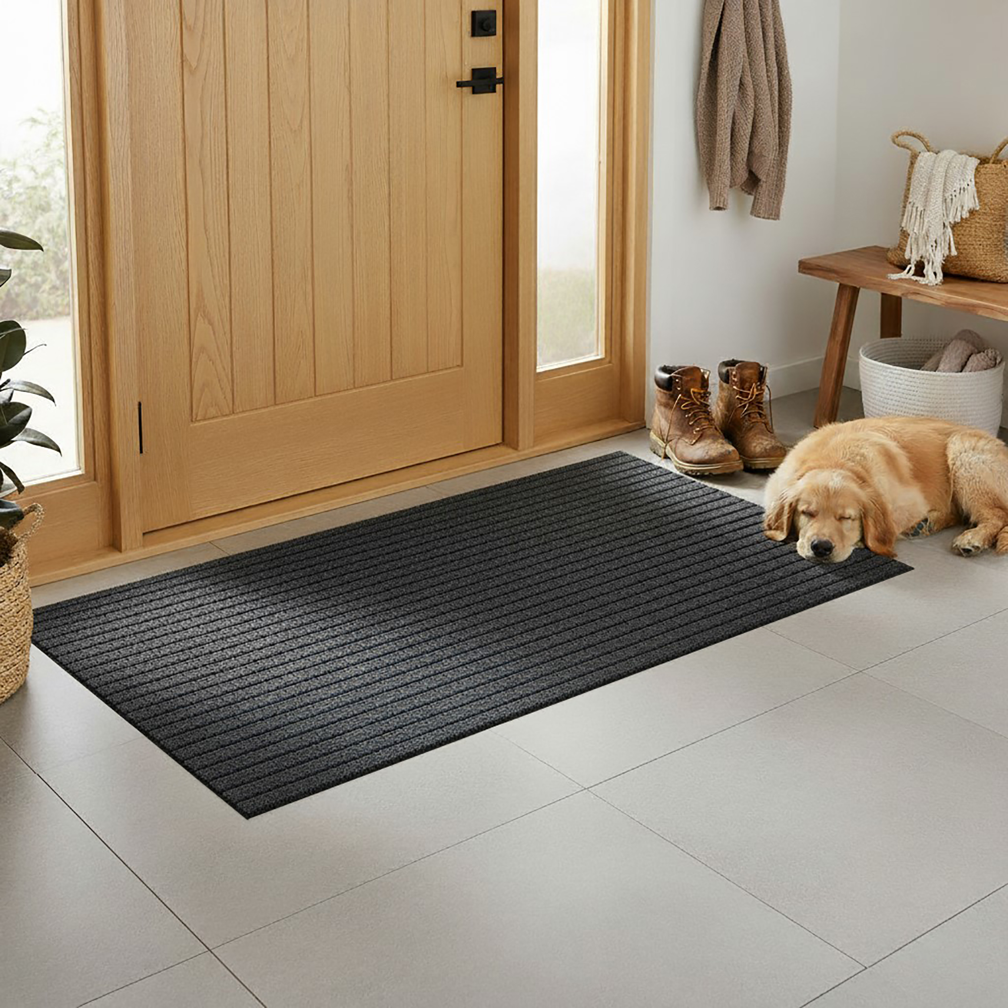 Entryway brushing doormat placed in front of a wooden door in a home entry