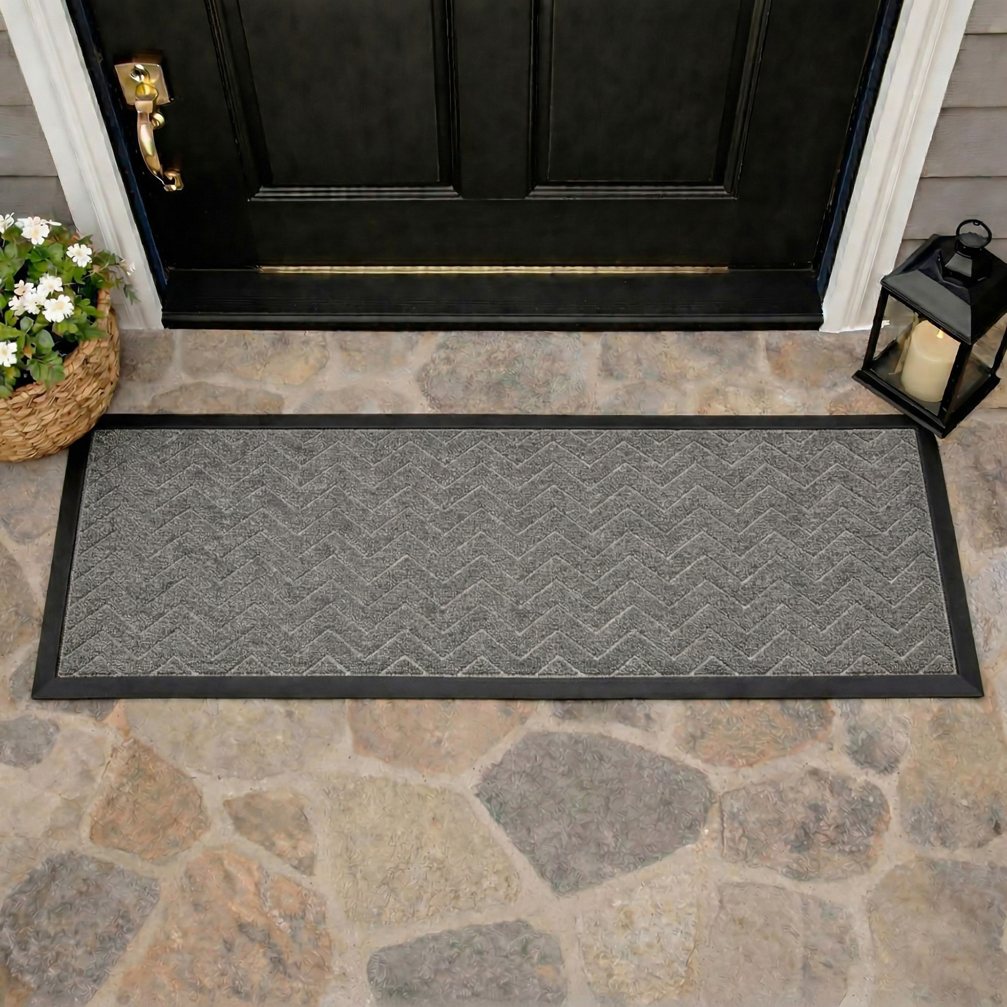 Runner doormat at front door threshold stone floor chevron pattern