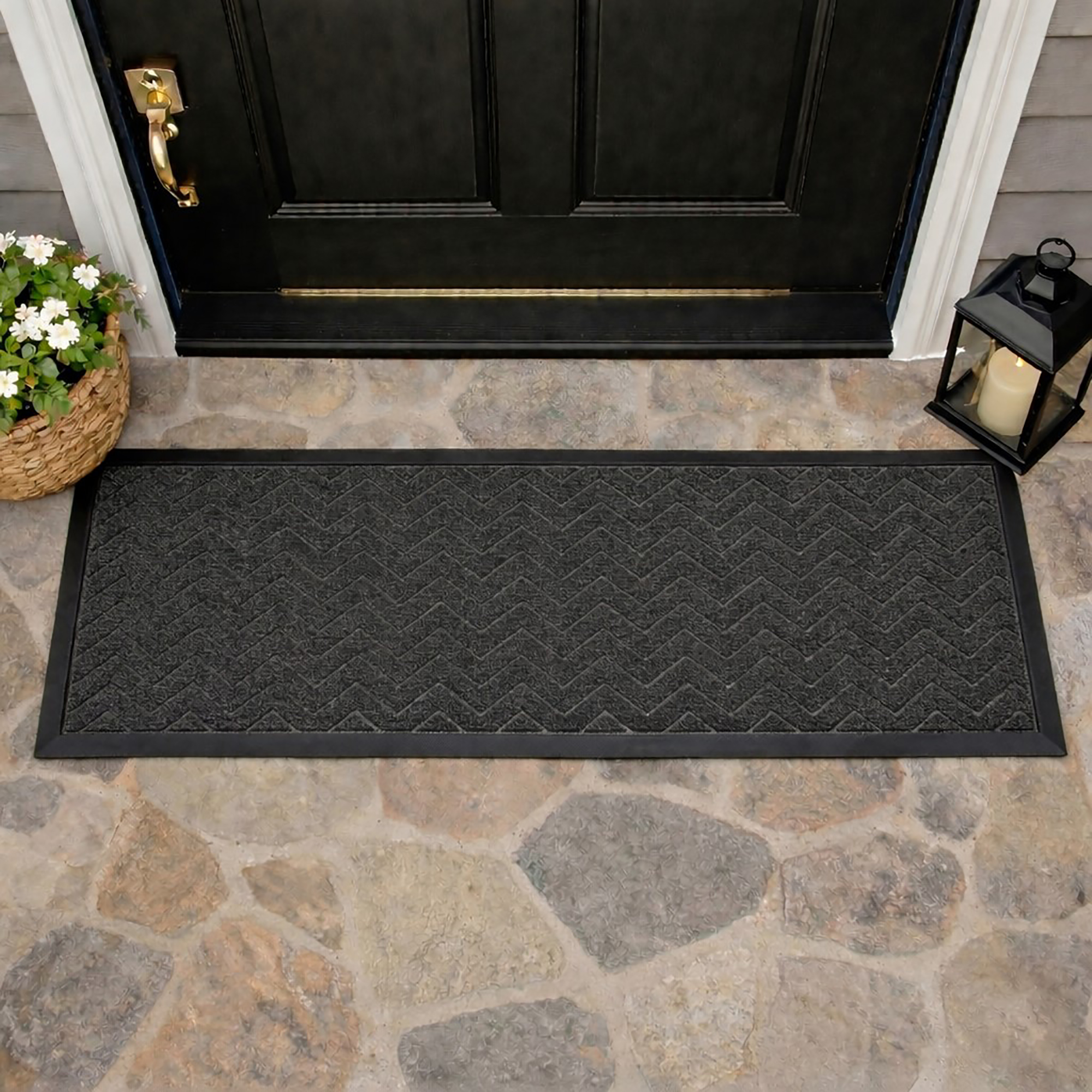 Runner doormat at front door threshold stone floor chevron pattern