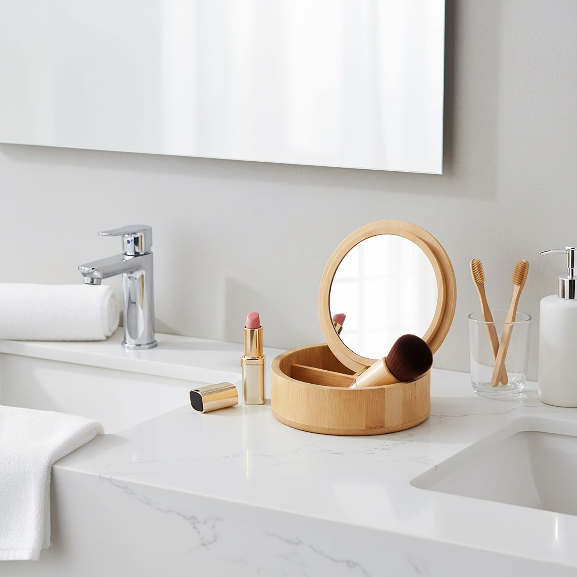 Bamboo organizer box with mirror open on a bathroom countertop with makeup items