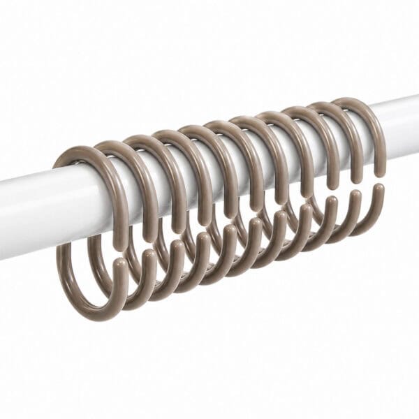 Soft tone rings arranged on rod highlighting neutral bathroom accessory color