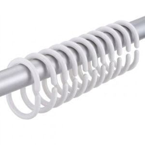 White plastic shower curtain hooks arranged on metal rod showing slim curved shape and smooth finish
