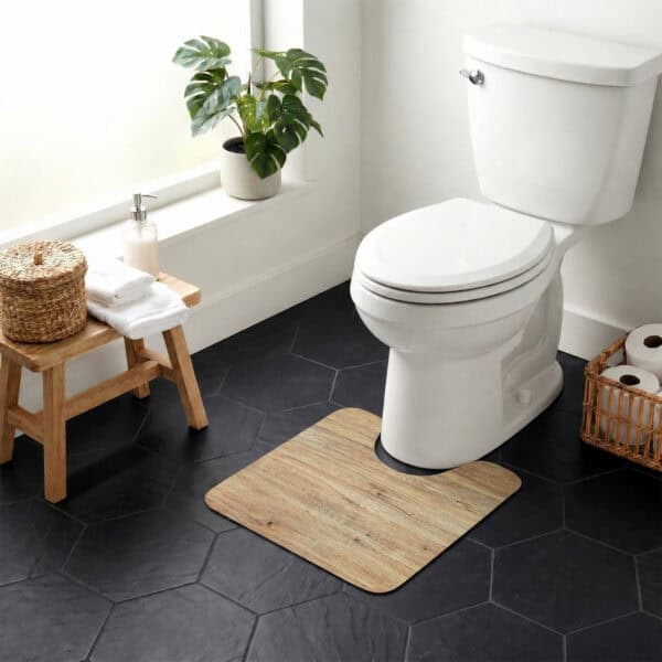 Oak Wood contour mat styled around toilet in bright bathroom with monstera plant and dark hexagonal tile floor