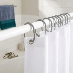 Gray rings holding white shower panel in clean bathroom installation view
