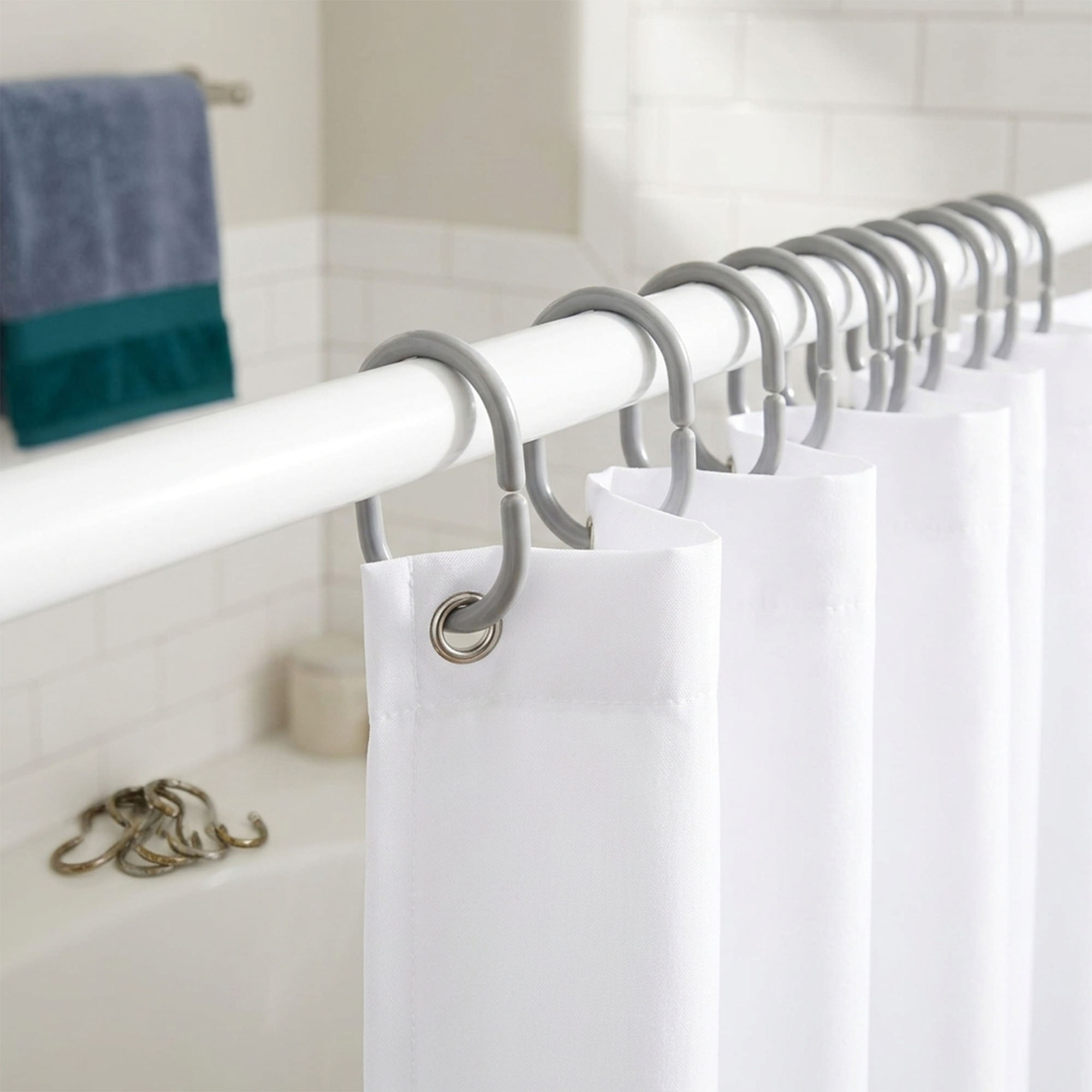 Gray rings holding white shower panel in clean bathroom installation view