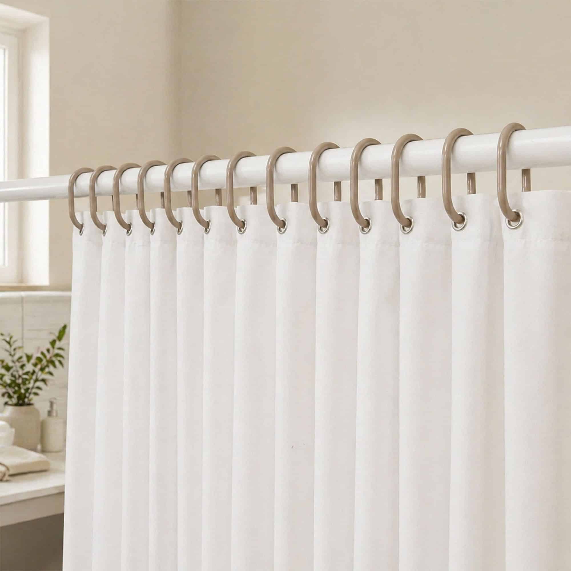 Light bathroom scene with neutral rings holding curtain in calming setup
