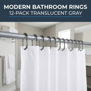 Gray shower curtain rings holding white curtain in modern bathroom with towel rack and mirror