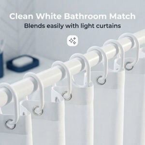 White shower hooks holding light curtain fabric blending into clean minimal bathroom decor