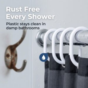 White plastic shower curtain hooks on wet rod showing resistance to moisture in humid bathroom