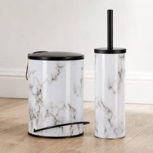 Coordinated marble bathroom set with a matching step trash can and toilet brush holder side by side, glossy white bodies with matte black lids.