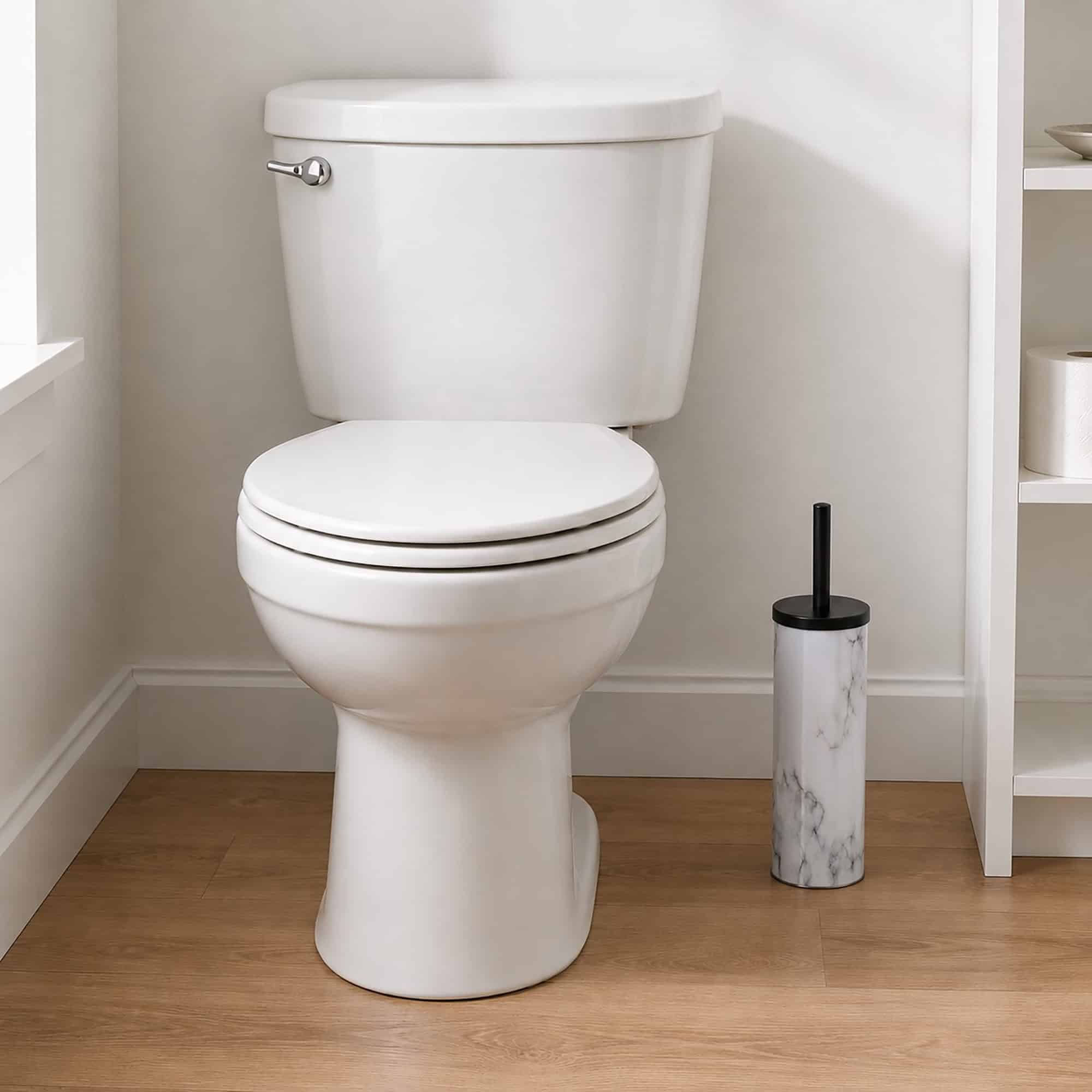 Slim marble look toilet brush holder placed beside a white toilet in a clean neutral bathroom, compact stand that tucks into a narrow corner.