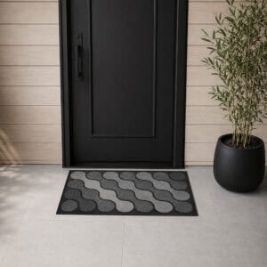 Gray ripple pattern outdoor rubber doormat placed at modern black front door entry with light wood cladding and minimalist planter, contemporary home exterior
