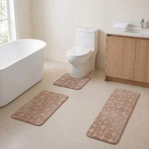Caramel 3-piece bath rug set displayed in a modern bathroom with freestanding tub, toilet and wood vanity.
