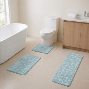 Light blue 3-piece bath rug set displayed in a modern bathroom with freestanding tub, toilet and wood vanity.