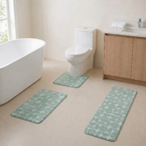 Sage green 3-piece bath rug set displayed in a modern bathroom with freestanding tub, toilet and wood vanity.