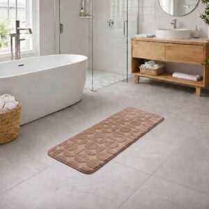 Caramel long bathroom runner placed between bathtub and vanity in a modern bathroom with light tile floor and natural daylight, soft plush comfort along the entire length