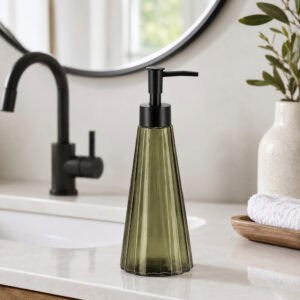 Olive green glass soap dispenser styled on a modern white bathroom vanity with matte black faucet and round mirror