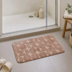 Caramel plush bath mat at the exit of a walk-in glass shower, modern Scandinavian bathroom with light tile floor and natural daylight, soft landing after every shower