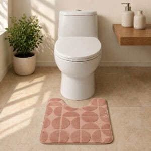 U-shape caramel bath mat in a minimalist spa-style bathroom with stone tile floor and natural sunlight