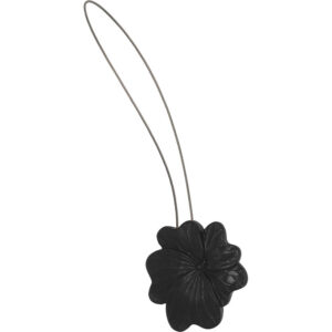 01 (hero packshot): Matte black metal flower curtain tieback with a thin silver cable loop, shown against a plain background to highlight the sculpted petal detail.