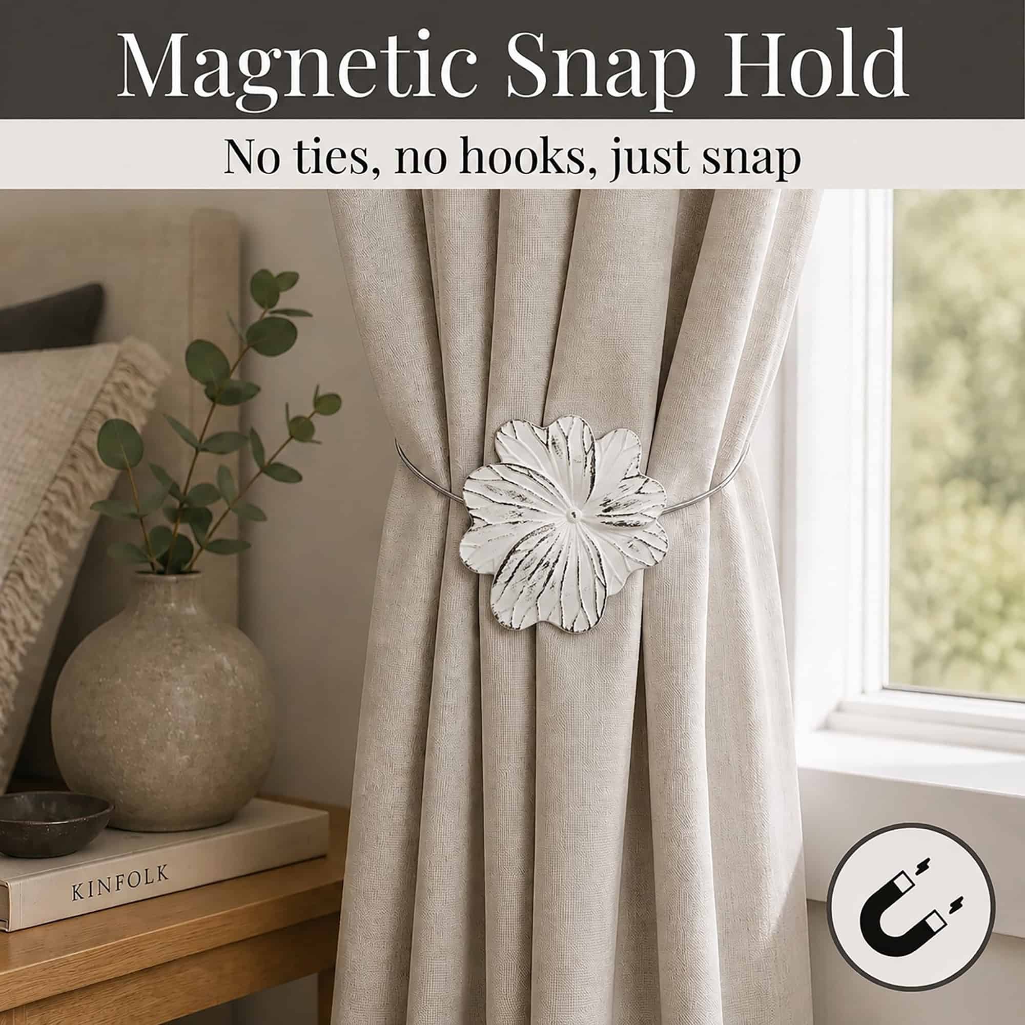 02 (magnetic snap hold): White flower tieback holding a gathered oatmeal linen curtain beside a styled nightstand, its magnetic ends snapping shut with no ties or hooks needed.