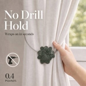 03 (no drill hold): A hand gathers a cream curtain held by the lightweight khaki flower tieback, which weighs about zero point four pounds and needs no drilling to install.