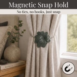 02 (magnetic snap hold): Khaki flower tieback holding a gathered oatmeal linen curtain beside a styled nightstand, its magnetic ends snapping shut with no ties or hooks needed.
