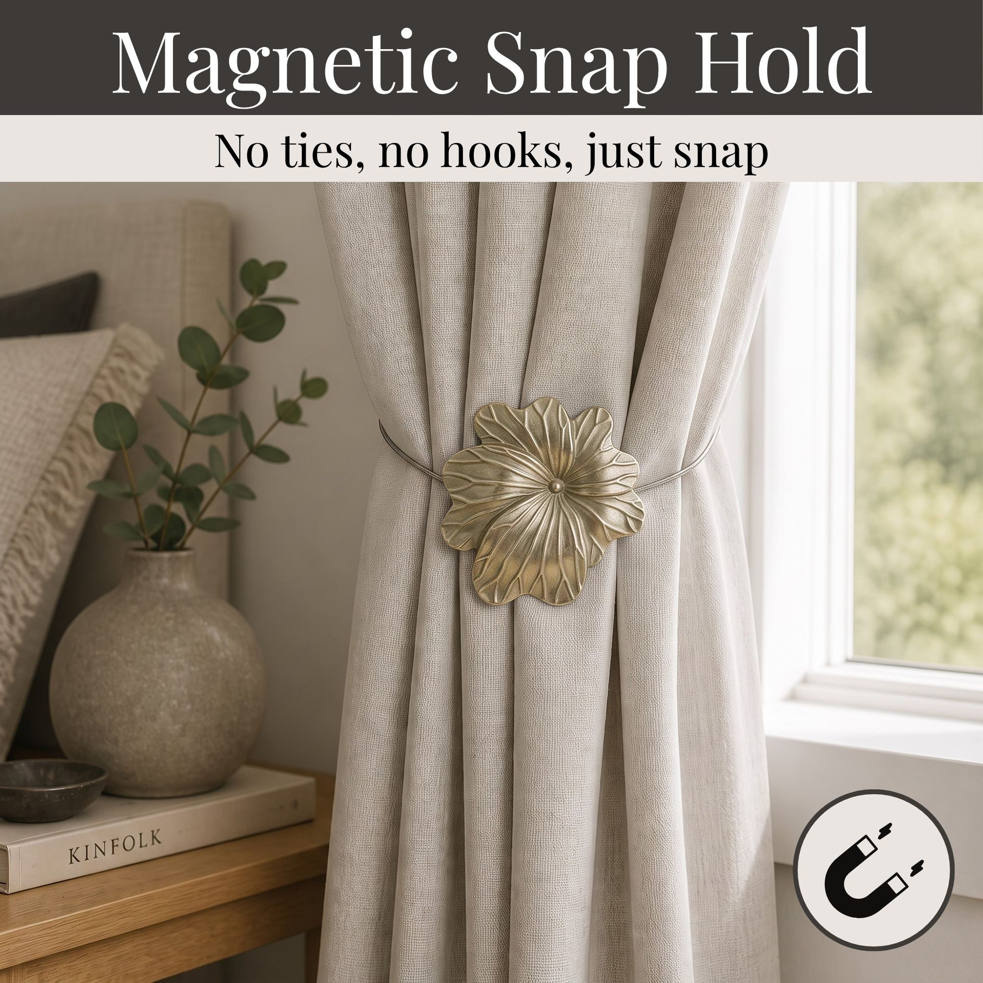 02 (magnetic snap hold): Matte gold flower tieback holding a gathered oatmeal linen curtain beside a styled nightstand, its magnetic ends snapping shut with no ties or hooks needed.