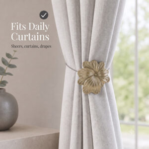 07 (fits daily curtains): Matte gold flower tieback gathering a greige linen curtain by a window, suited to everyday sheers, curtains, and drapes in a calm neutral setting.