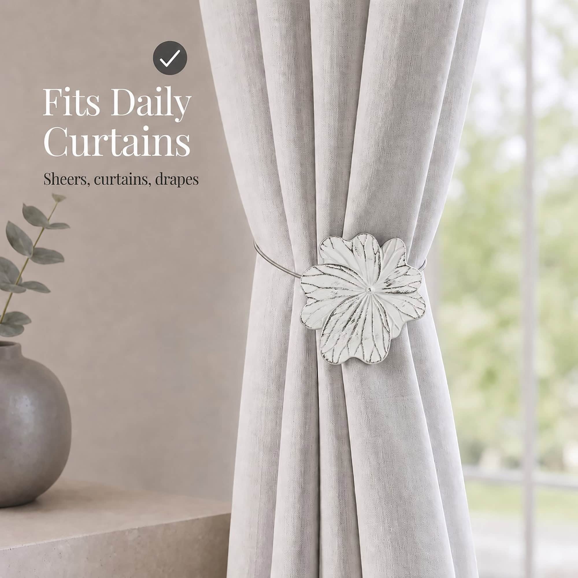 07 (fits daily curtains): White flower tieback gathering a greige linen curtain by a window, suited to everyday sheers, curtains, and drapes in a calm neutral setting.