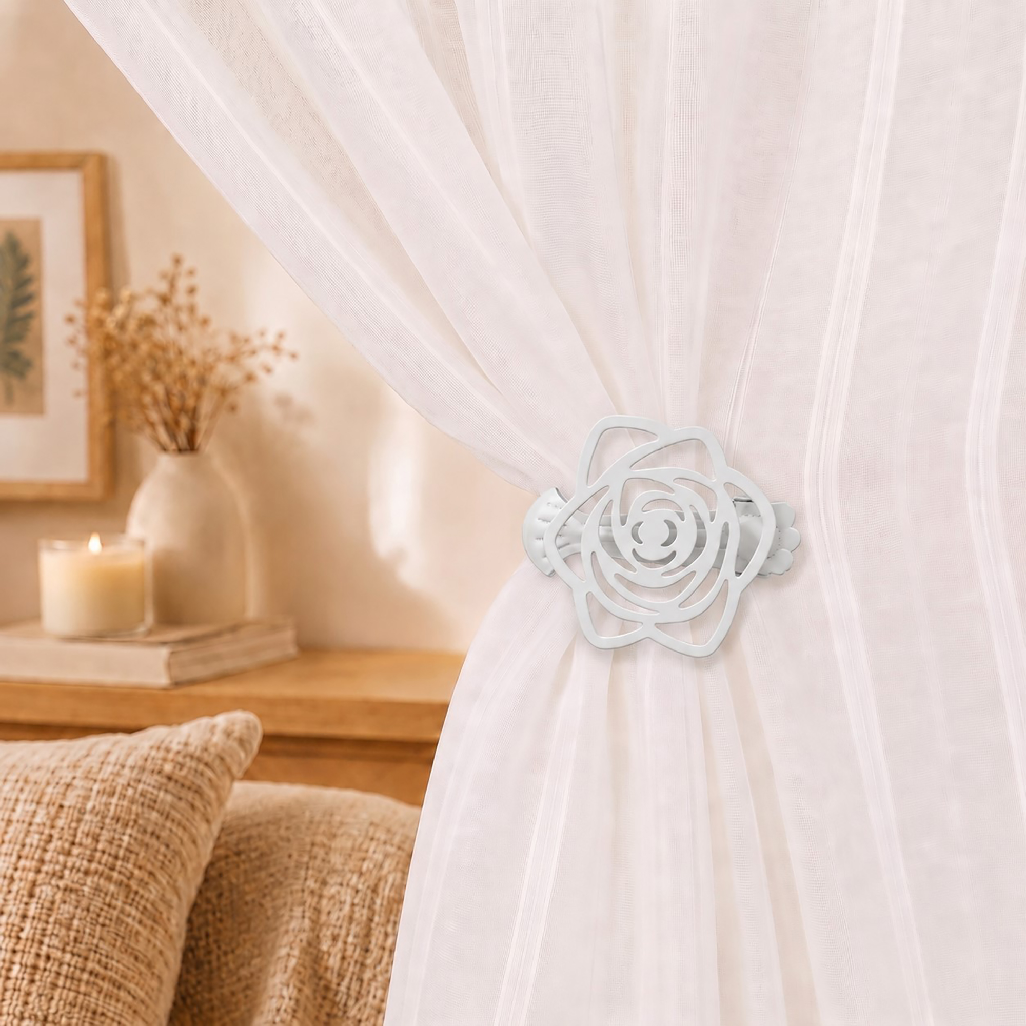 Close-up lifestyle view of a white cutout rose curtain tieback clip holding a sheer white fabric curtain in a cozy bedroom setting.