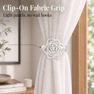 Close-up of a white rose tieback clip gripping a lightweight sheer curtain panel, featuring the text "Clip-On Fabric Grip. Light panels, no wall hooks."