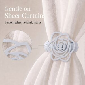 Close-up of a white rose curtain clip on a sheer panel with a circular zoomed-in callout highlighting its smooth, fabric-safe edges and text "Gentle on Sheer Curtains".