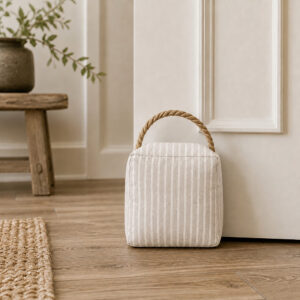 Gray ticking stripe door stop in a farmhouse hallway entryway