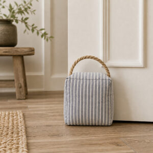 Blue ticking stripe door stop in a farmhouse hallway entryway