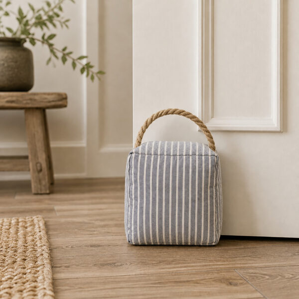 Blue ticking stripe door stop in a farmhouse hallway entryway